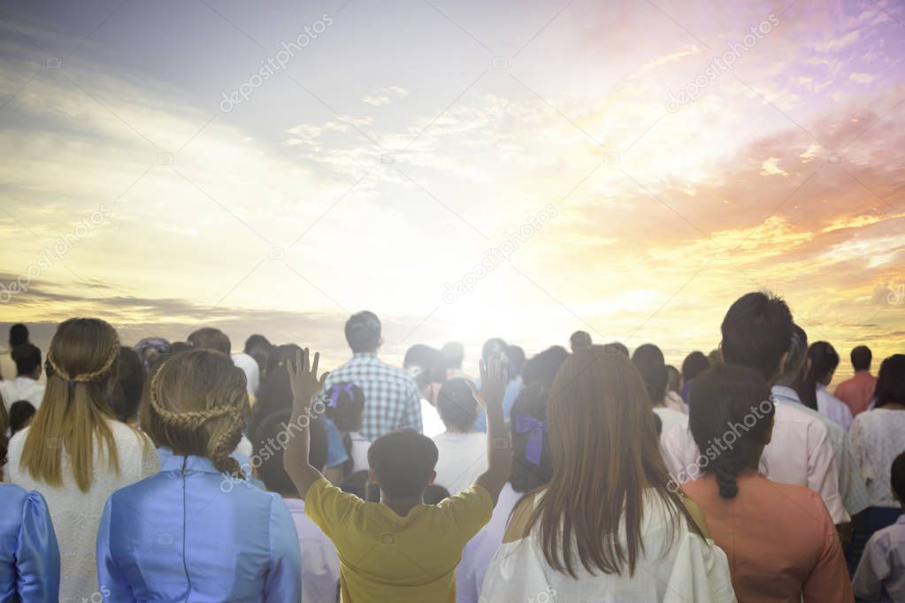 World environment day concept: Silhouette of man raised hands at meadow sunset background