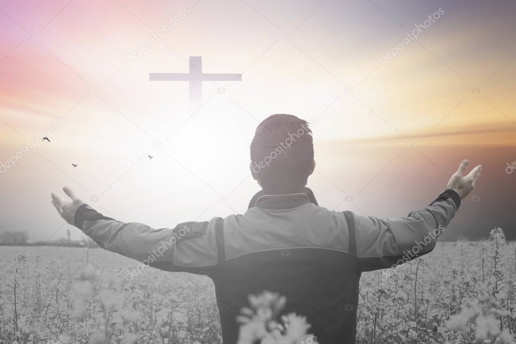 Resurrection of Easter Sunday concept: Silhouette cross on meadow sunrise background