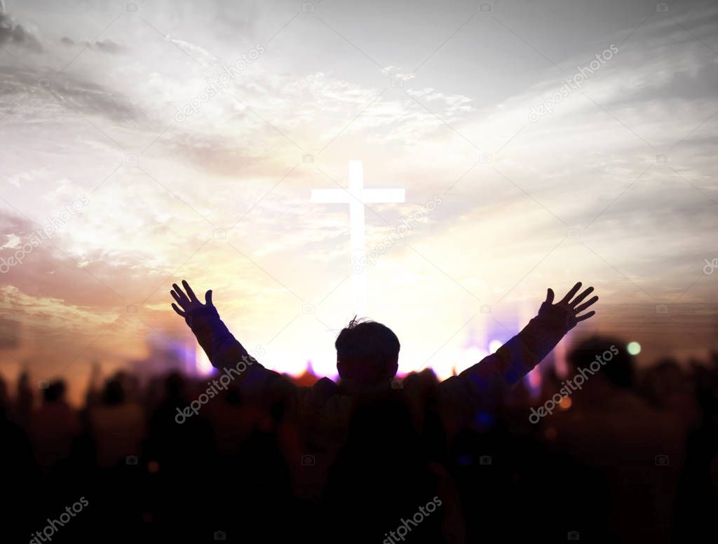 Church worship concept:Christians raising their hands in praise and worship at a night music concert