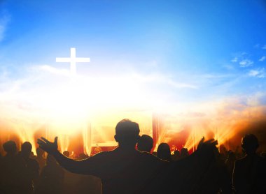 Church worship concept:Christians raising their hands in praise and worship at a night music concert clipart