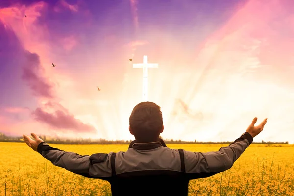 Resurrection of Easter Sunday concept: Silhouette cross on sunrise background