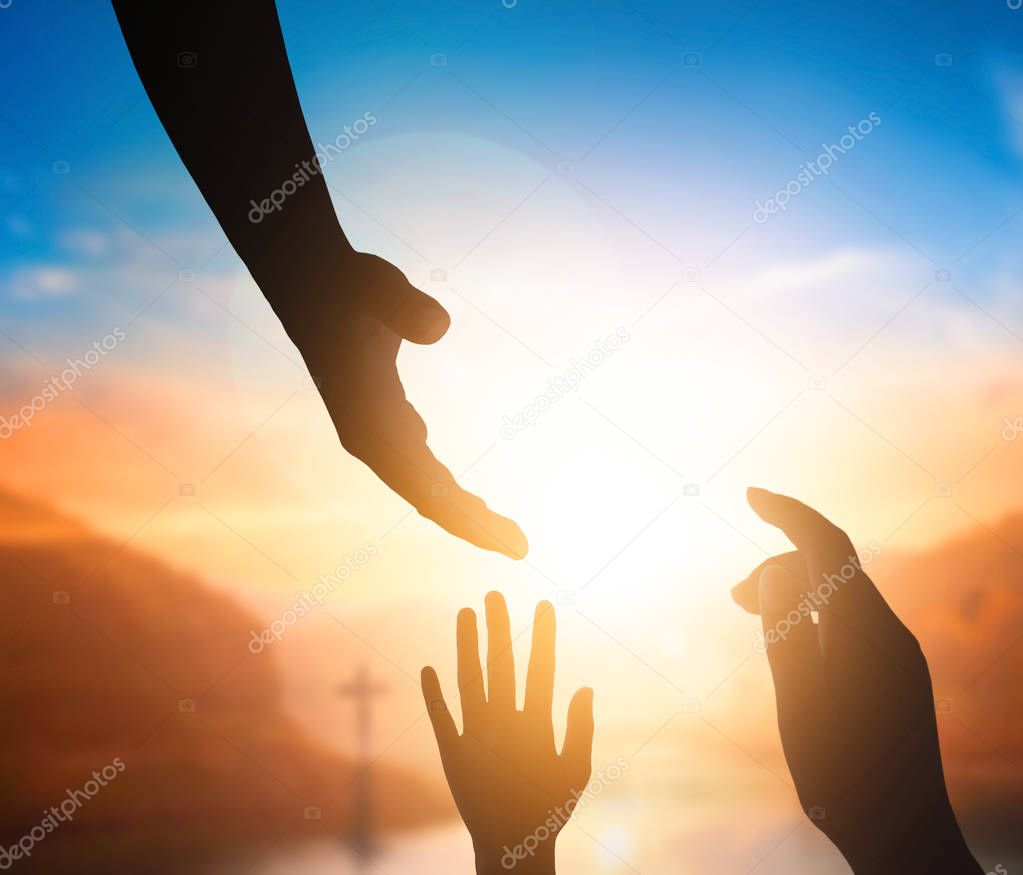 World Peace Day concept:Silhouette of Jesus reaching out hand
