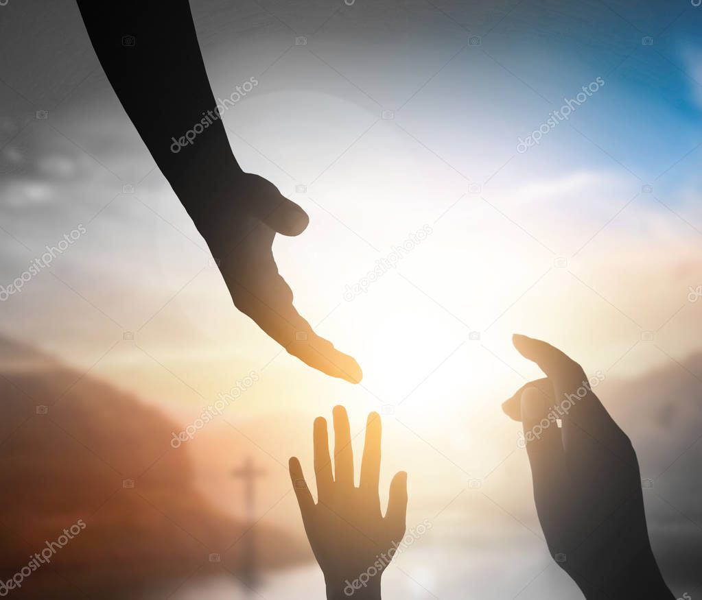 World Peace Day concept:Silhouette of Jesus reaching out hand