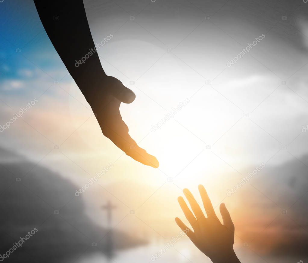 Praise and worship concept:Silhouette of Christian prayers raising hand while praying to the Jesus