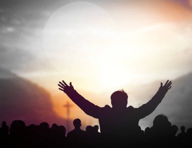 Praise and worship concept:Silhouette of Christian prayers raising hand while praying to the Jesus clipart