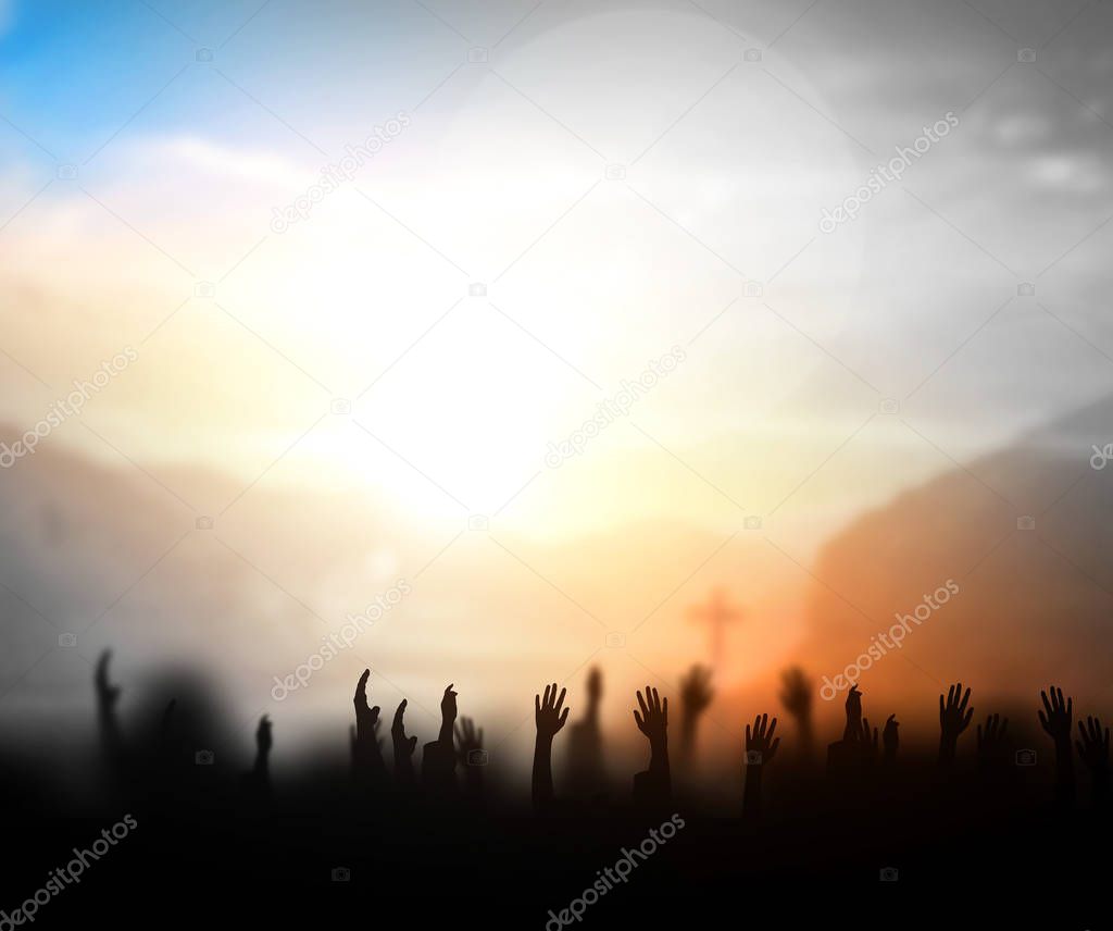 Praise and worship concept:Silhouette of Christian prayers raising hand while praying to the Jesus