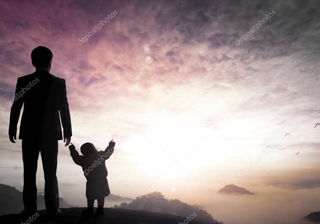 Father's Day concept: businessman father and child standing on the mountain top