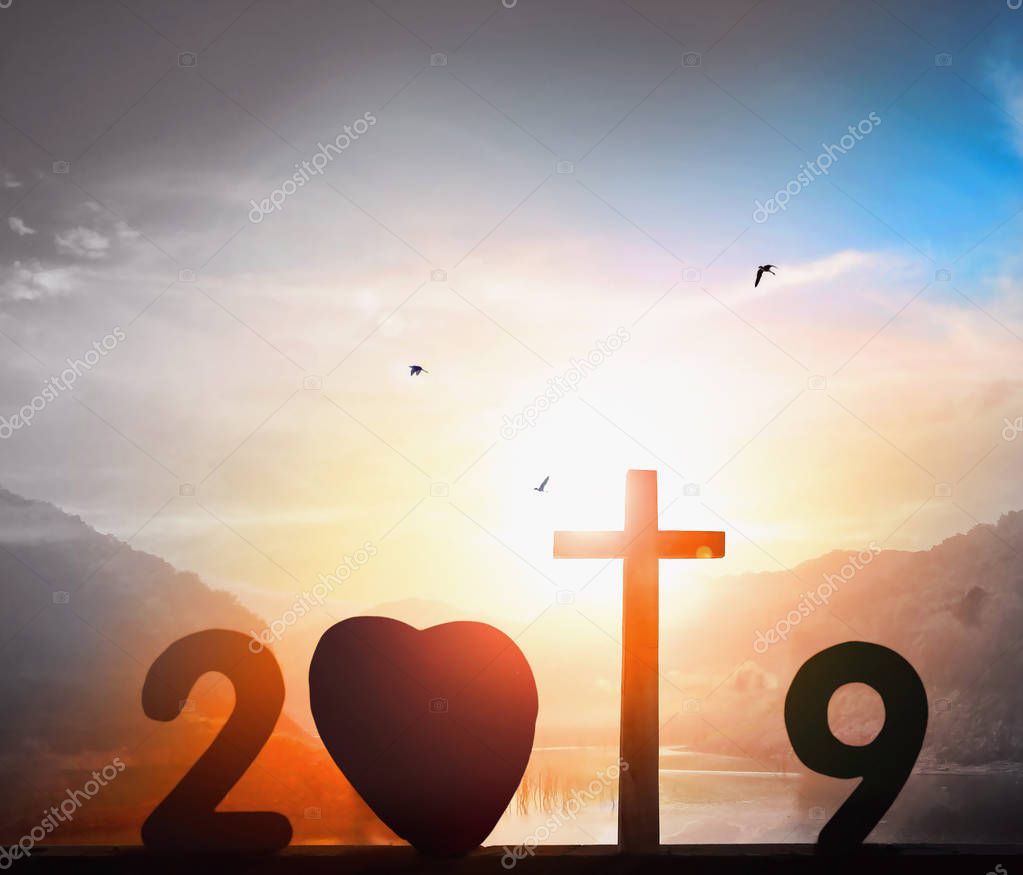 2019 Christmas Concept: Cross of Christ Jesus on Sunset Background