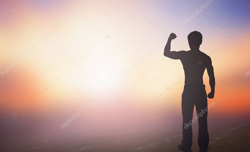 International human rights day concept: Silhouette of man raised hands at   sunset background