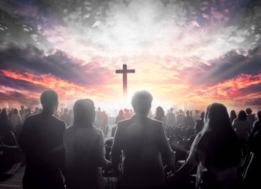 Worship concept:  christian people hand in hand over  cross on spiritual sky background clipart