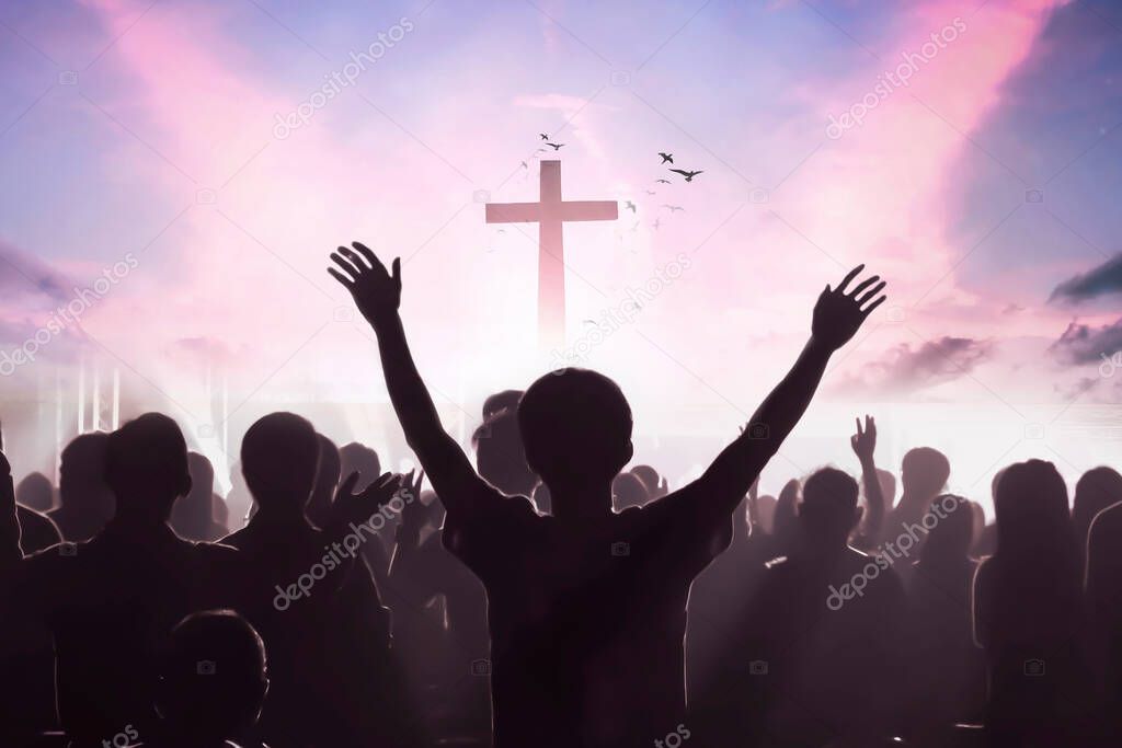 Worship concept: christian people Raise hand over cross on spiritual sky background