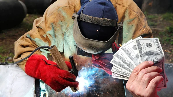 Hand Holding Dollar Bills Front Pipeline Welder Work Protective Equipment Stock Photo