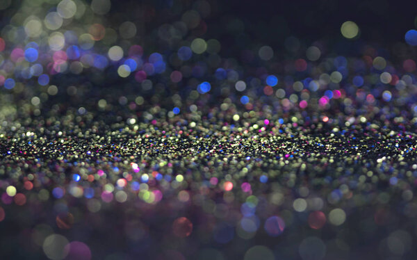 Bokeh glitter fly and lights on black background