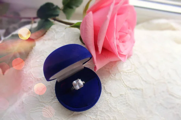 Beautiful blue box with wedding ring. The background of the wedding day. White on white. White shoes. wedding shoes. Bride`s high heels. The fees of the bride. Wedding jewelry.
