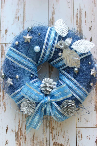 新年背景 圣诞节背景 装饰蓝色的圣诞花环 在木制纹理的白色古老门 花圈特写镜头 圣诞锥 珠子和丝带 复制空间 — 图库照片