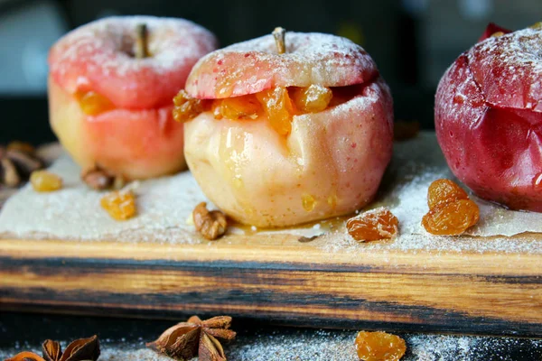 baked apple with christmas spices on wooden background