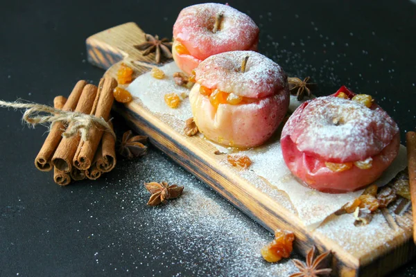 baked apple with christmas spices on wooden background