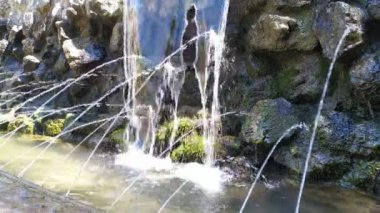 Küçük yapay küçük şelale, yavaş yavaş damla damla damla. Dış mekan görüntüleri.