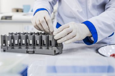 Hemşire kan bir tepsi ile test tüpleri düzenler