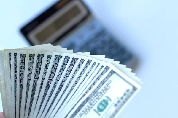 Man Holds One Hundred Dollar Banknotes Light Background Blurred Calculator — Stock Photo, Image