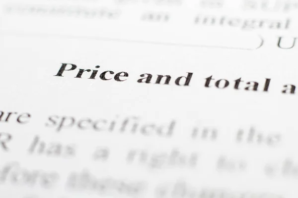 A fragment of the contract with the terms of price increase. Macrophoto conditions about price and total cost close up. The buyer and the seller made a contract on paper. Selective focus.