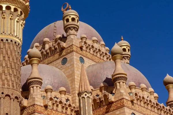 Old eastern architecture on a background of blue sky close-up. B