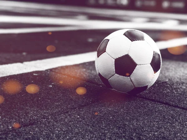 Soccer ball on the playground with bokeh. Ball for playing stree