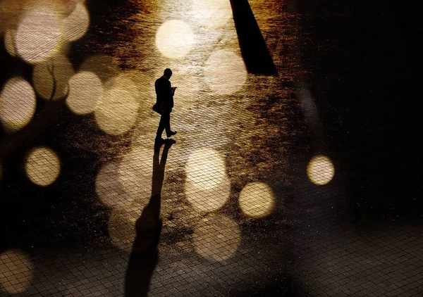 Silhouette of a man in a business suit on the square in abstract