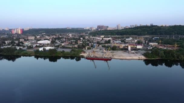 Sessiz bir yaz sabahında nehir kıyısına demirlemiş nehir kumu çıkartmak için kullanılan kırmızı bir geminin panoraması. Mavic 2 Pro Drone 'da Hava Uzunluğu Görüntüsü. — Stok video