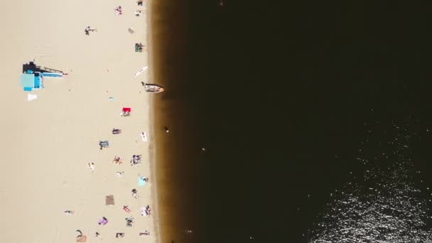 Beach landscape top view drone - people lie on a sandy bank near the river and sunbathe — Stock Video