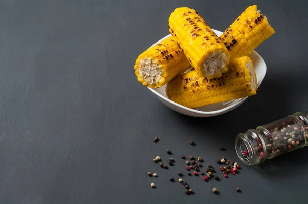 Whole White Ceramic Plate Full Fried Corn Cobs Scattered Pepper — Stock Photo, Image