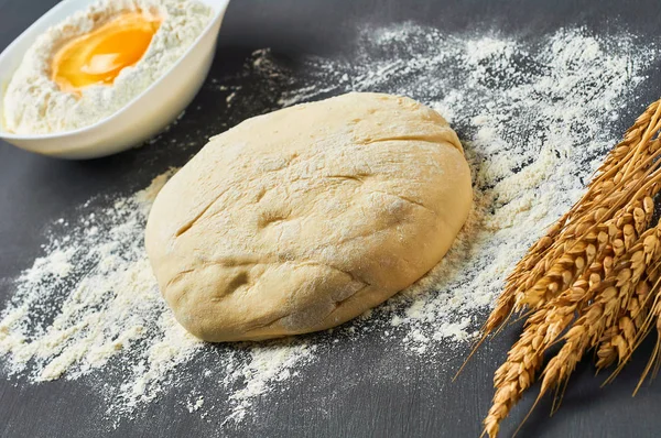 Farklı mutfak eşyaları ve malzemeler yakın un ile Hamur koyu beton masa üzerinde yatıyor. Pişirme işlemi