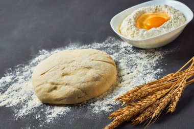 Farklı mutfak eşyaları ve malzemeler yakın un ile Hamur koyu beton masa üzerinde yatıyor. Pişirme işlemi. Kopyalama alanı
