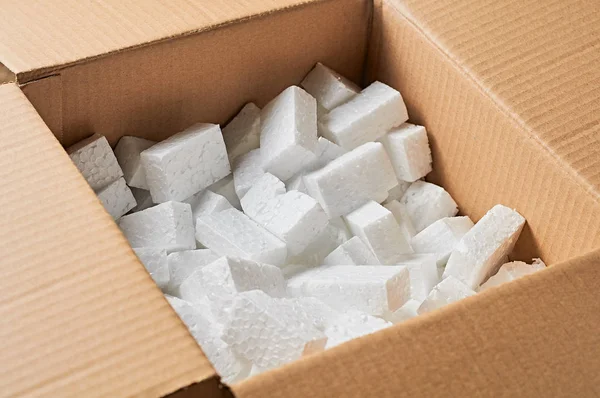 Open square cardboard box for parcels full of rectangular styrofoam blocks