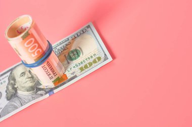 Pembe arka planda farklı banknotlar. Emekli maaşları, maaşlar. Banka kredisi. İş konsepti