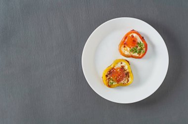 Beton masadaki restoranda kızarmış yumurtayla doldurulmuş dolma biber halkaları servis ettim. Lezzetli kahvaltı.