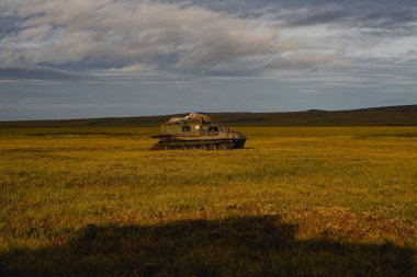 Trip on far east of Russia along autumn tundra clipart