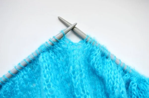 Knitting a blue sweater