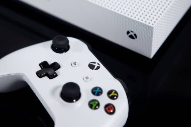 A White XBOX One S System and Controller on Black clipart