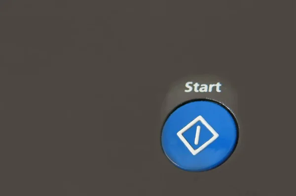 a blue start button on the black background