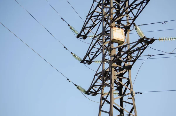 Transmission power lines against the blue sky. Electricity. Electric pole, electrical wire.