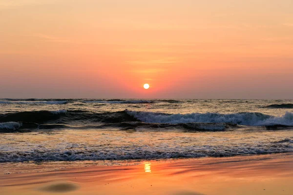 Beautiful sky colorful sunset on the ocean, natural landscapes. Deserted beach, the sun sets in the clouds above the sea.