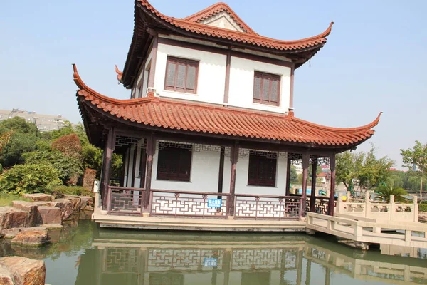 Single Chinese building. The Chinese building lonely standing on the coast of a pond.