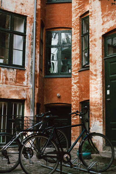 Row of bicycles near old building at street of Copenhagen, Denmark
