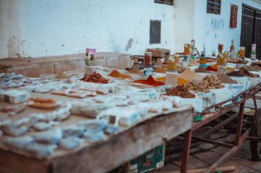 piles of aromatic spices on tables at Chefchaouen market, Morocco clipart