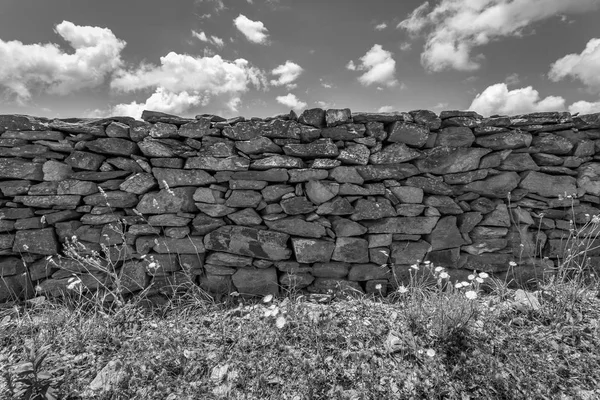 Old wall texture. Wall texture and background. Stones background. Abstract texture and background for designers. Closeup view of rock wall and stones in monochrome