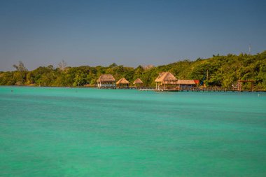 Laguna de Bacalar, Meksika 'nın Bacalar şehrinde bulunan Yedi Renk Gölü olarak da bilinir. Kristal berrak sular ve gölün beyaz kumlu tabanı su renginin gün boyunca değişen turkuaz, mavi ve derin çivit renklerine dönüşmesine neden olur.