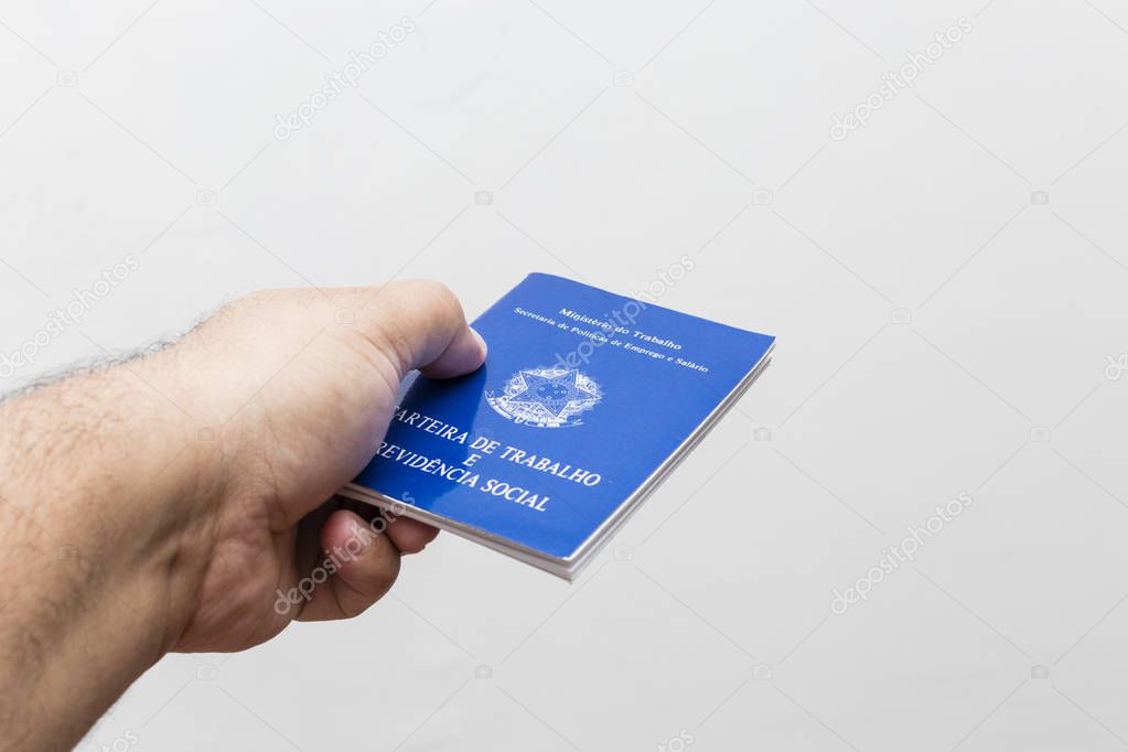 hands of middle-aged man holding work book, Brazilian social security document