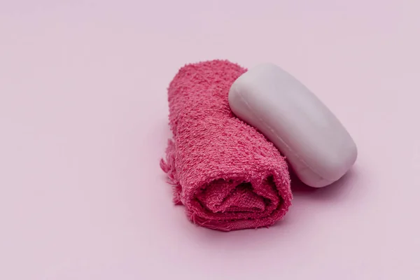 towel wrapped with soap, pink background