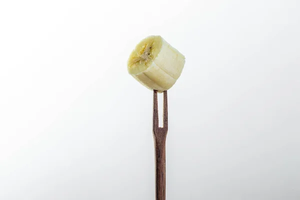 Zbliżenie Kawałek Banana Wzbogacony Małym Drewnianym Widelcem — Zdjęcie stockowe